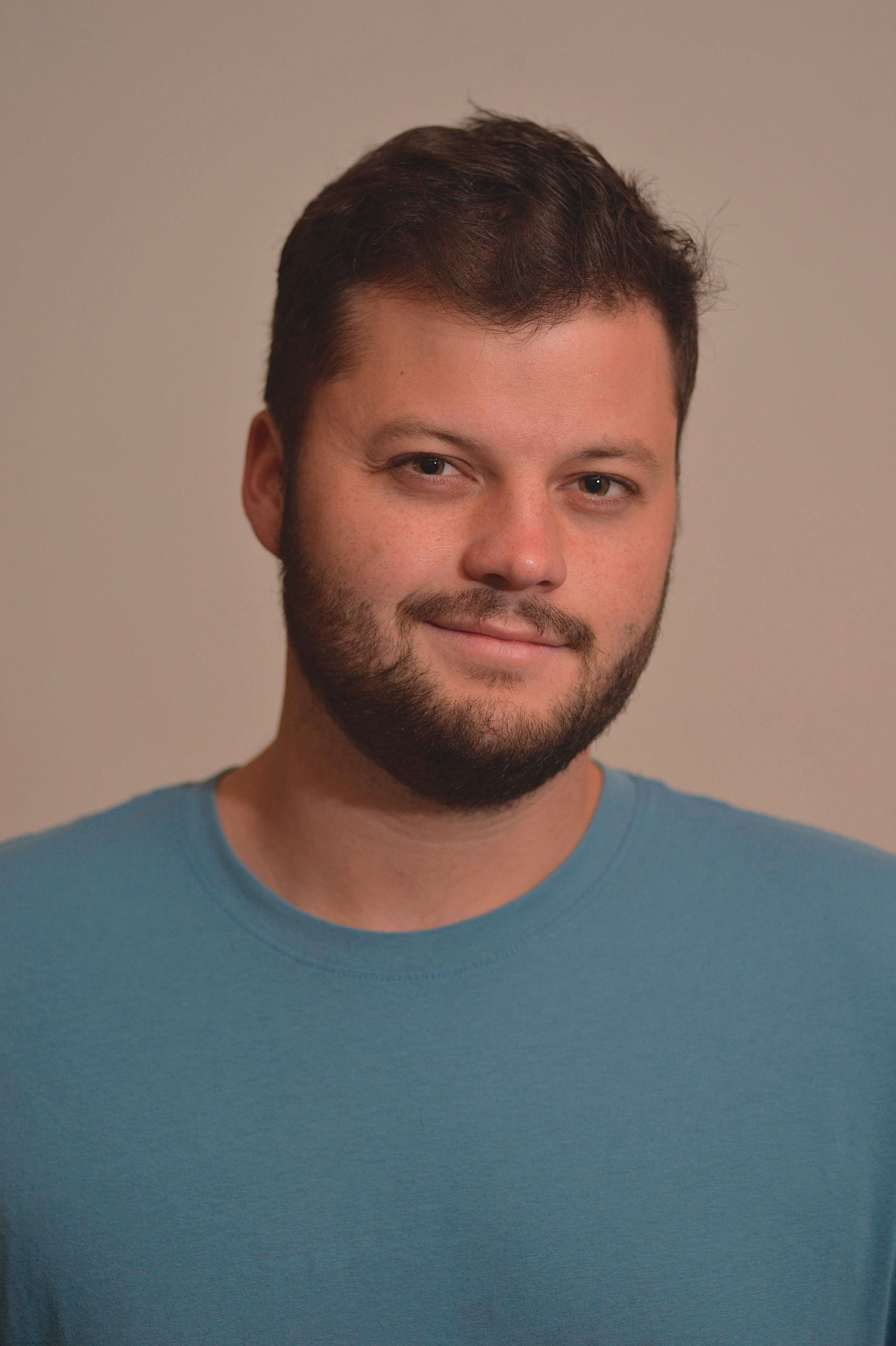 a man with a beard looking at the camera
